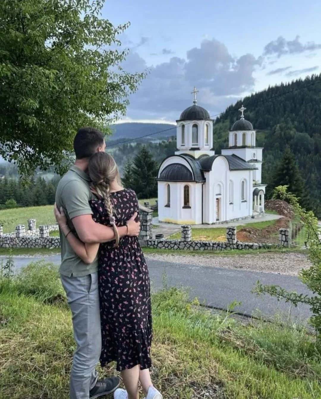 A couple standing together outside a village church