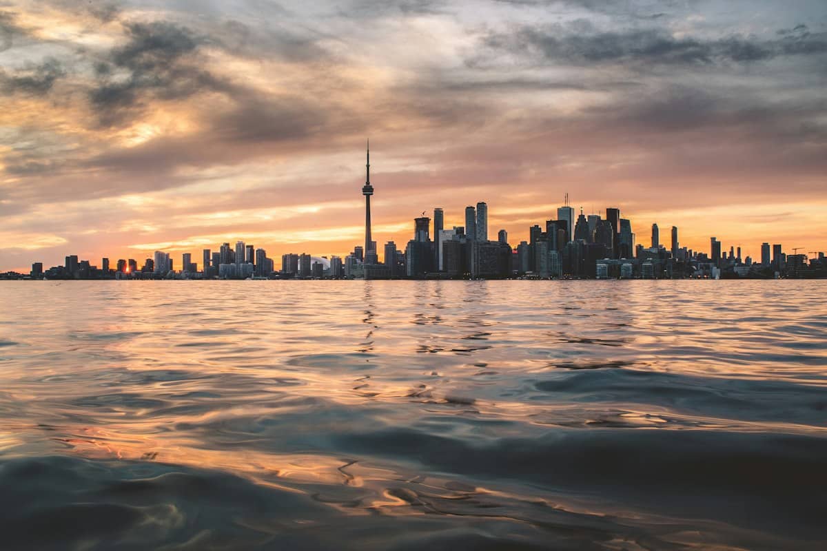 The Toronto skyline and the CN Tower across Lake Ontario at sunset