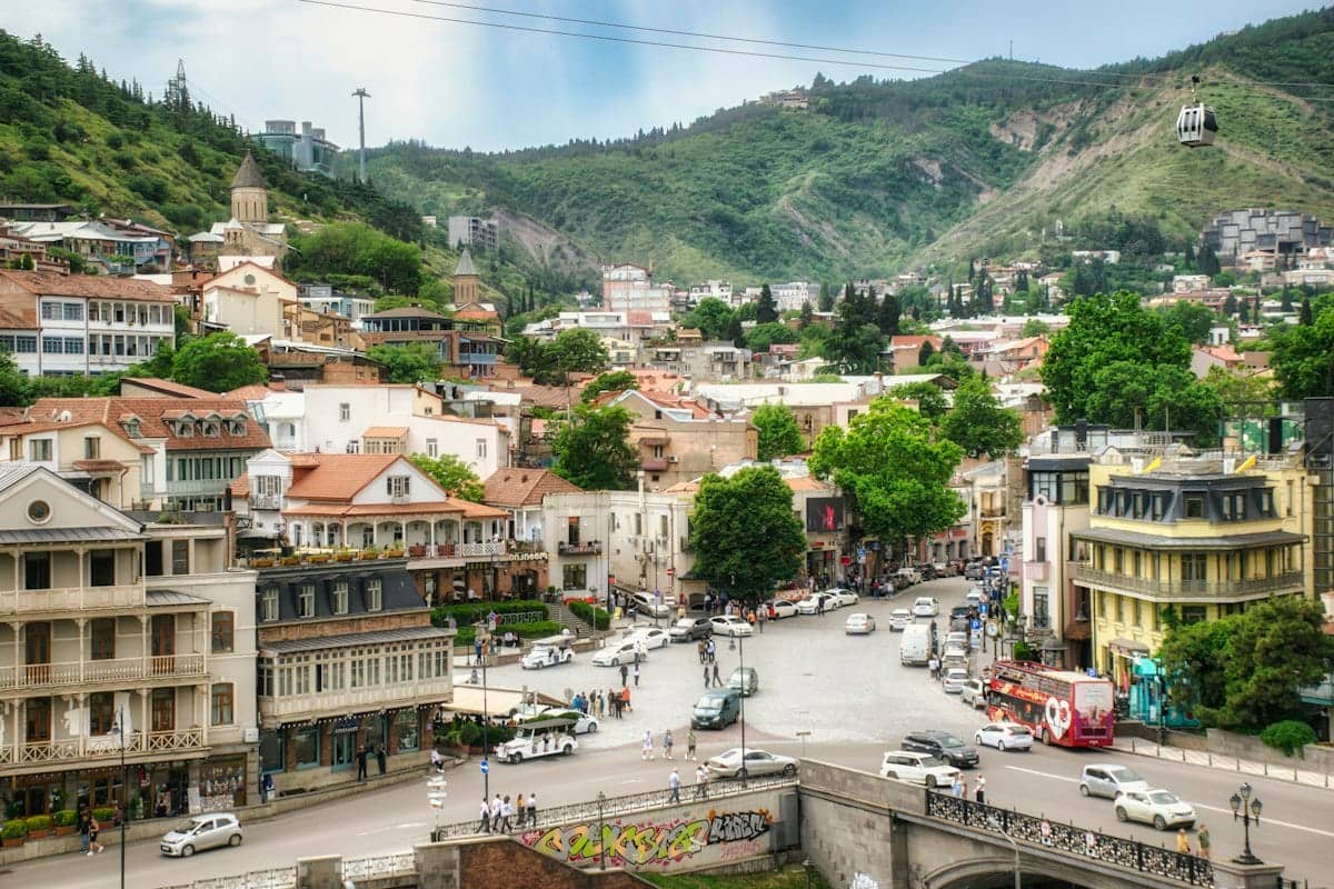 The old town of Tbilisi below the hills, with balconied houses along the street